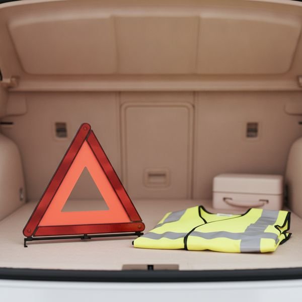 A reflective warning triangle and hi-vis vest
